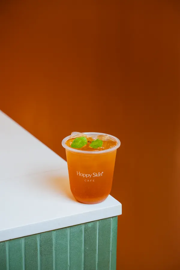 Iced tea on a white counter against an orange wall
