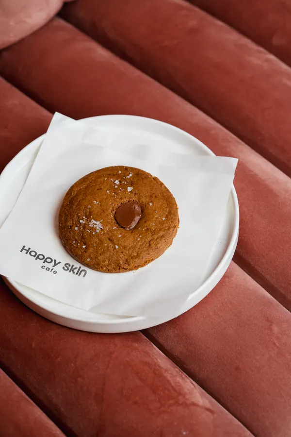 Cookie on a plate on a pink velvet seat