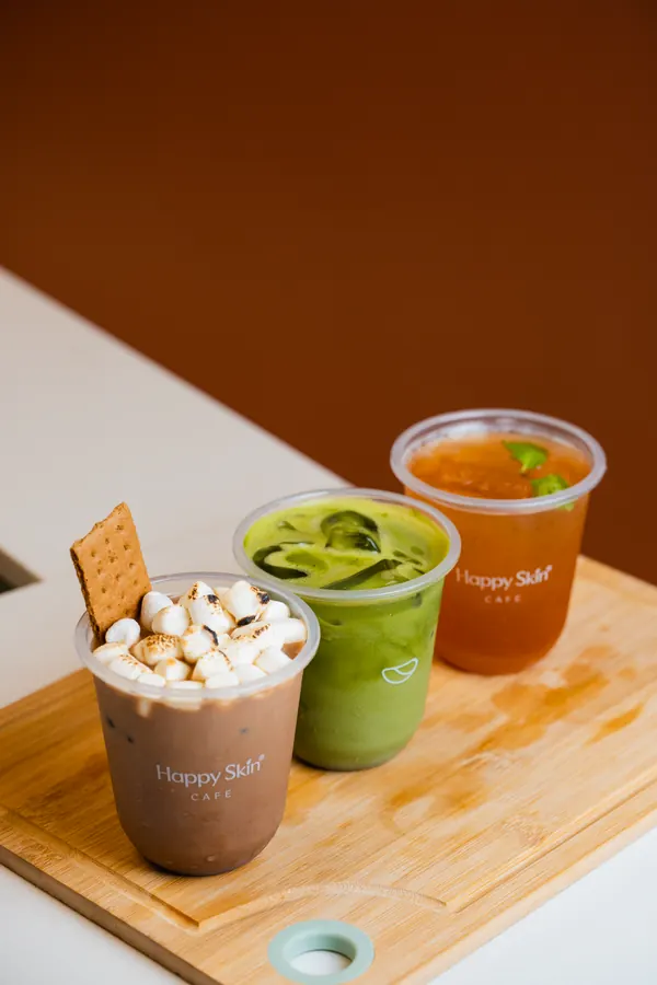 Three drinks on a wooden board