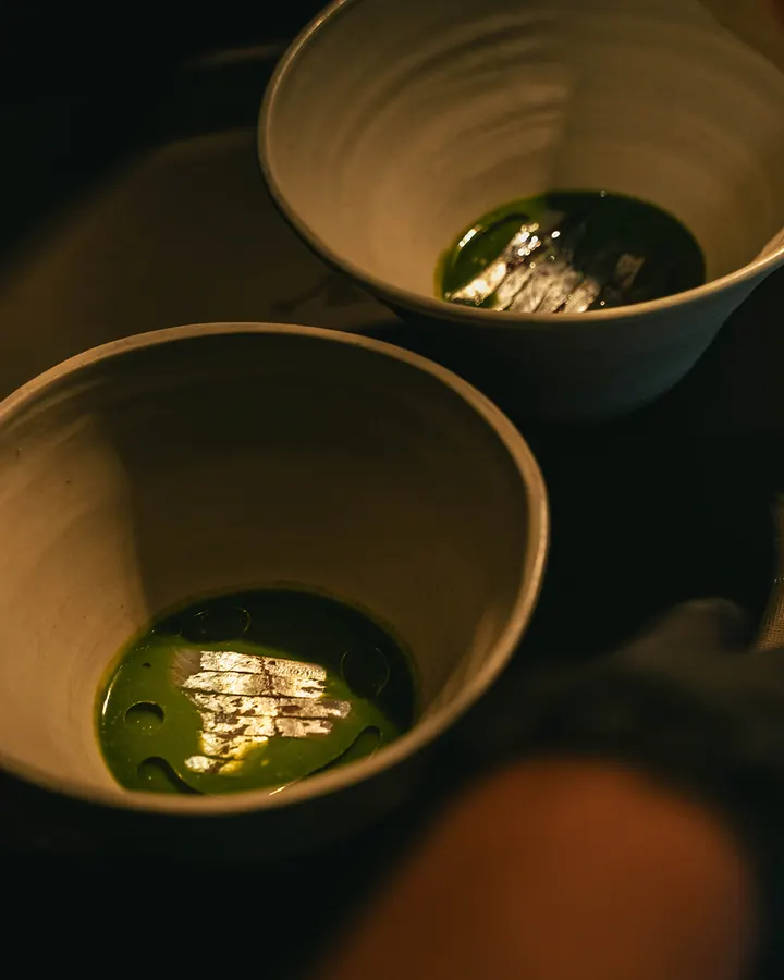 Green broth in ceramic bowls
