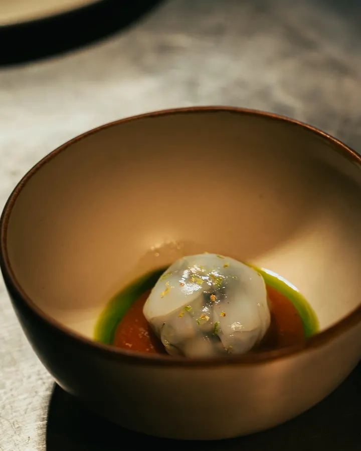 Dessert in a ceramic bowl with green sauce