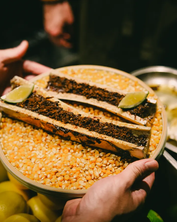 Bone marrow on a bed of corn with lime