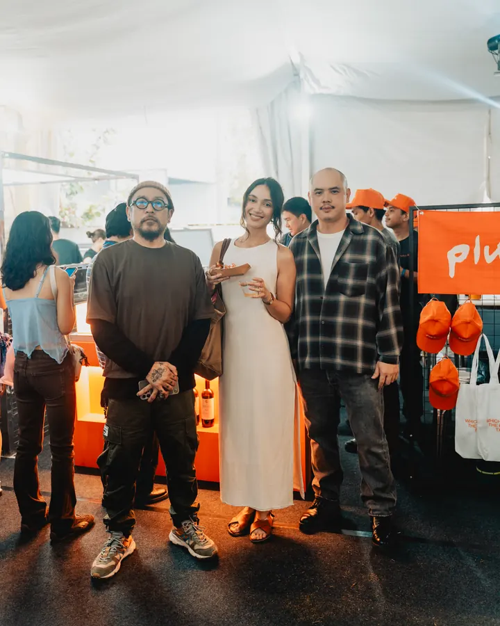 Guests posing at the Pluck booth