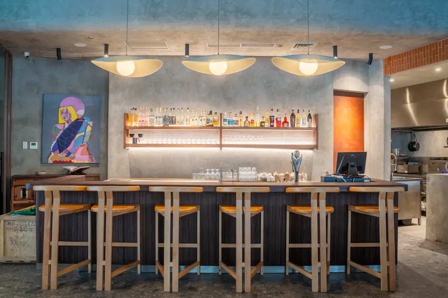 Bar counter with stools under pendant lights