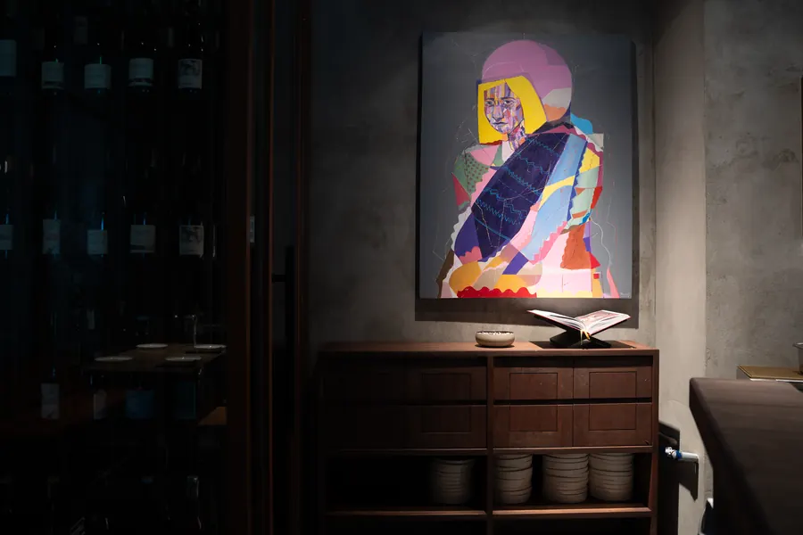 Portrait painting lit in a dark corner