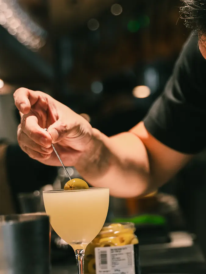 Olive garnish placed on a cocktail