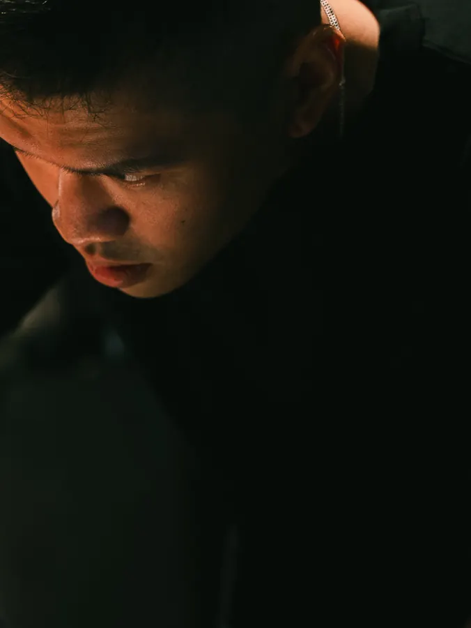 Close-up of Royce Pua in low light
