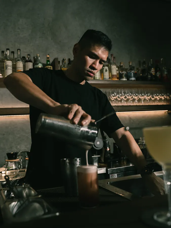 Shaking a cocktail behind the bar