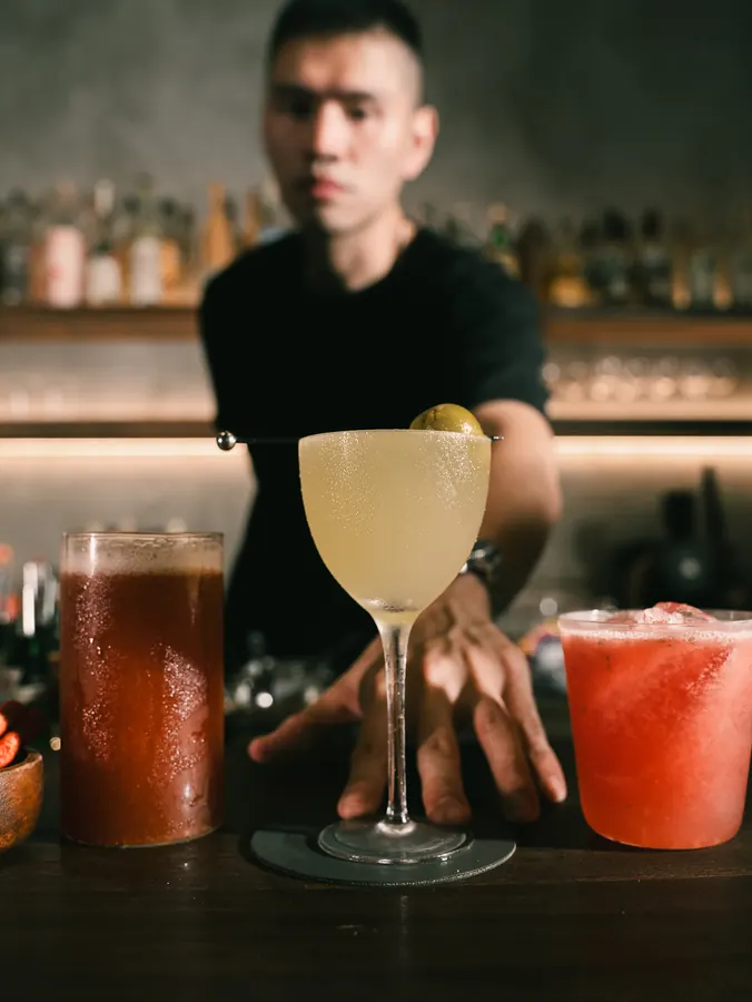 Three finished cocktails on the bar